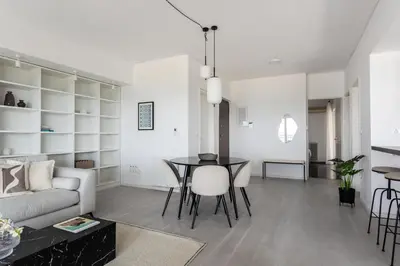 a living room with a table and a couch at Alimos 2BR Apartment with Splendid Sea View by UPSTREET in Athens