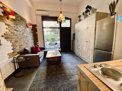 a kitchen and living room with a couch and a refrigerator at Sophia Luxury Loft in Athens
