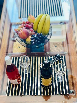 a bowl of fruit on top of a table with glasses at Sophia Luxury Loft in Athens