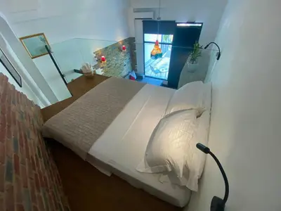 a bedroom with a large bed with a video game at Sophia Luxury Loft in Athens