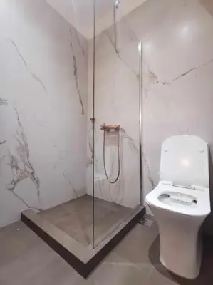 a bathroom with a toilet and a glass shower at CDV stylish Athens flat in Athens