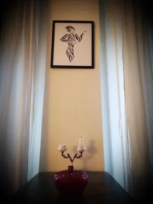 a table with a vase on a table with two candles at CDV stylish Athens flat in Athens