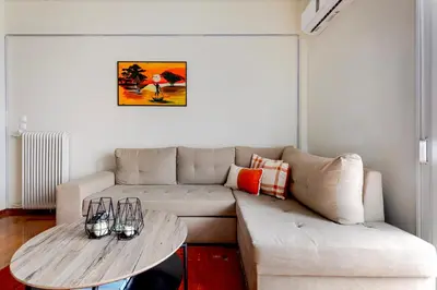 a living room with a couch and a table at Lina's Home in Athens