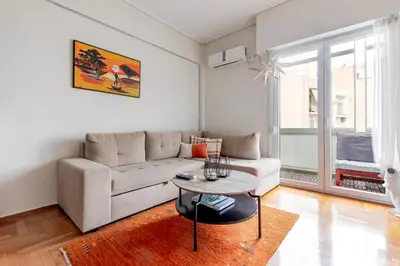 a living room with a couch and a table at Lina's Home in Athens