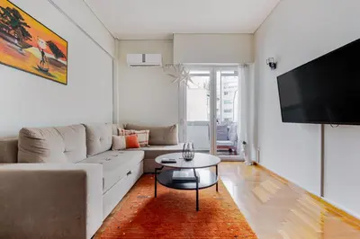 a living room with a couch and a table at Lina's Home in Athens