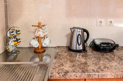 a kitchen counter with a tea kettle and a toaster at morfo's sunset in Sounio