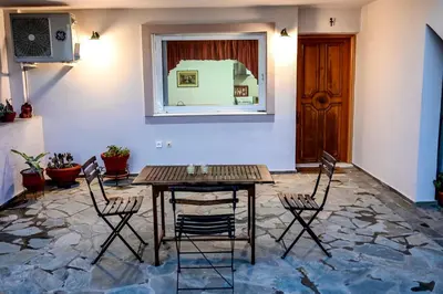 a room with a table and chairs and a window at morfo's sunset in Sounio