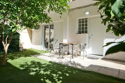 a table and chairs in front of a house at Marine Cocoon & Terrace Modern Apt, Private Garden in Athens