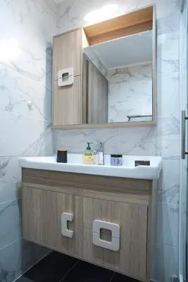 a bathroom with a sink and a mirror at Marine Cocoon & Terrace Modern Apt, Private Garden in Athens