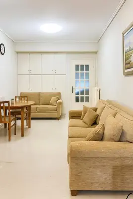 a living room with two couches and a table at Mamour Apartments, Near Tram & 8' to Beach, Queen Bed Comfort in Athens