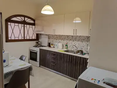 a kitchen with white cabinets and a sink at ALΚO central PARK ATHENS in Athens