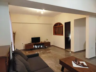 a living room with a couch and a tv at ALΚO central PARK ATHENS in Athens