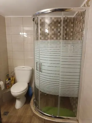 a bathroom with a toilet and a glass shower at ALΚO central PARK ATHENS in Athens