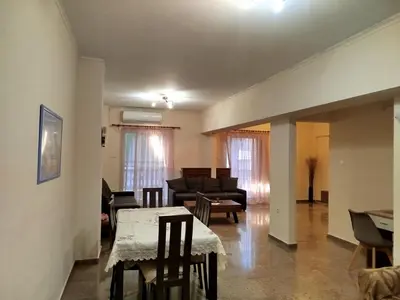 a living room with a table and a couch at ALΚO central PARK ATHENS in Athens