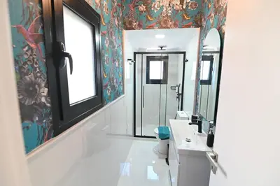 a bathroom with a sink and a mirror at Warm & cozy studio - apartment 2 in Athens