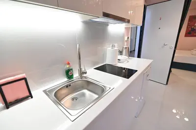 a kitchen with a sink in a white counter top at Warm & cozy studio - apartment 2 in Athens