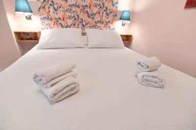 a bedroom with a bed with white towels on it at Warm & cozy studio - apartment 2 in Athens