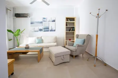a living room with a couch and a chair at Apollon Apartment and Museum Acropolis in Athens