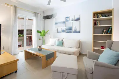 a living room with a couch and a table at Apollon Apartment and Museum Acropolis in Athens