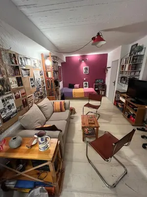 a living room with a couch and a table at Cozy quiet studio near the sea in Athens