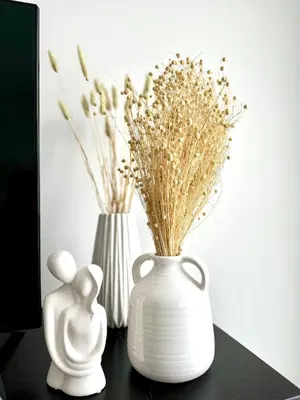 two white vases with flowers in them on a table at GRACE Apartment Next to the Akropolis in Athens