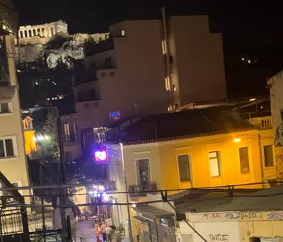 a yellow building on a city street at night at GRACE Apartment Next to the Akropolis in Athens