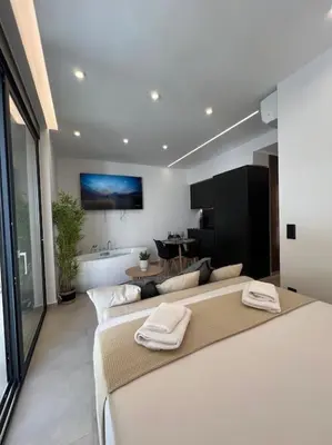 a bedroom with a large bed with two towels on it at BlueMotion - PortSuite 5A in Piraeus