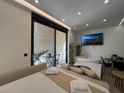 a bedroom with a bed and a room with a tub at BlueMotion - PortSuite 5A in Piraeus