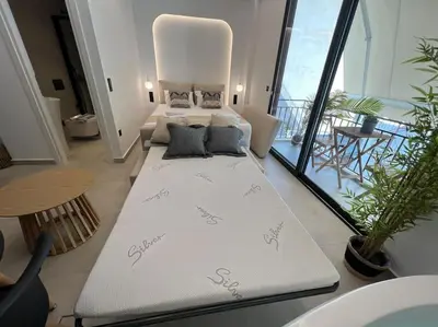 a large white couch in a room with a large window at BlueMotion - PortSuite 5A in Piraeus