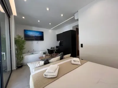 a bedroom with a large bed and a bath room at BlueMotion - PortSuite 5A in Piraeus