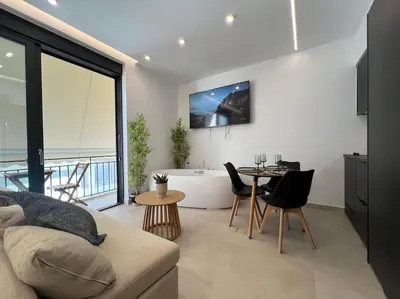 a living room with a couch and a table and a tub at BlueMotion - PortSuite 5A in Piraeus
