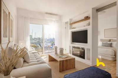 a white living room with a couch and a tv at Marina View Haven - King Beds and Cosy Fireplace in Piraeus