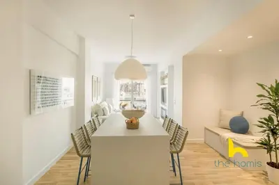 a living room with a table and chairs and a couch at Marina View Haven - King Beds and Cosy Fireplace in Piraeus