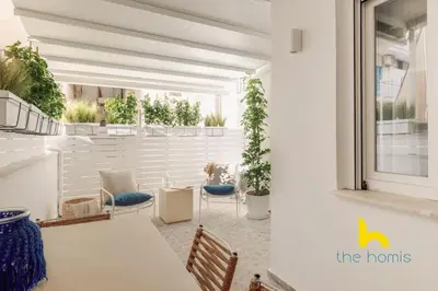 a room with a table and chairs and plants at Marina View Haven - King Beds and Cosy Fireplace in Piraeus