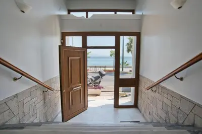 an open door leading to the beach from a house at SeaLiv Apartment by LobbySquare in Piraeus
