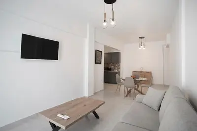 a living room with a couch and a table at SeaLiv Apartment by LobbySquare in Piraeus