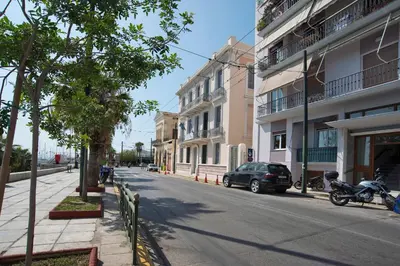 a street with a car parked on the side of the road at SeaLiv Apartment by LobbySquare in Piraeus