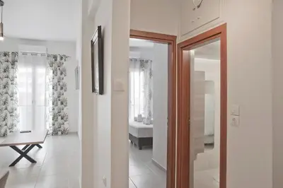 a hallway with a door leading to a bathroom at SeaLiv Apartment by LobbySquare in Piraeus