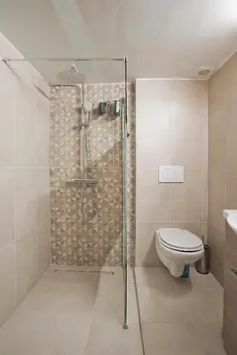 a bathroom with a shower and a toilet at SeaLiv Apartment by LobbySquare in Piraeus