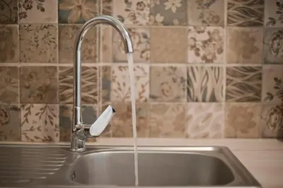 a kitchen sink with a faucet with a soap dispenser at SeaLiv Apartment by LobbySquare in Piraeus