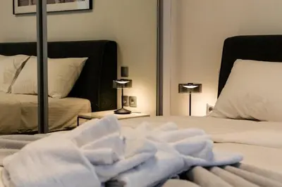 a bedroom with two beds with white towels on them at Bright and Stylish Apartment in Palaio faliro in Athens