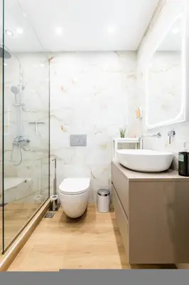 a bathroom with a sink and a toilet and a shower at Bright and Stylish Apartment in Palaio faliro in Athens