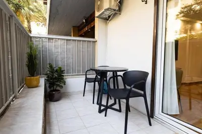 a small balcony with a table and chairs at Bright and Stylish Apartment in Palaio faliro in Athens