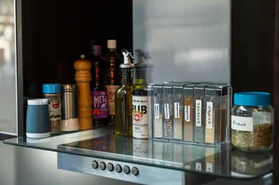 a glass shelf in a refrigerator with bottles of alcohol at Indoor pool villa, near the beach, Lagonisi in Kalívia Thorikoú