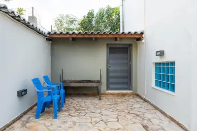 two blue chairs and a table on a patio at Indoor pool villa, near the beach, Lagonisi in Kalívia Thorikoú