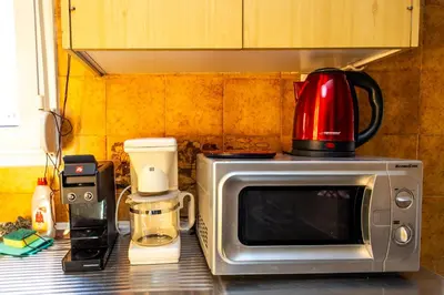 a microwave sitting on top of a kitchen counter at Ρετιρέ με θέα in Athens