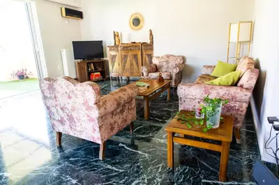 a living room with two chairs and a table at Ρετιρέ με θέα in Athens