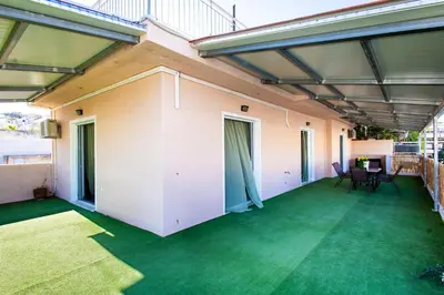 a large patio with green flooring in a house at Ρετιρέ με θέα in Athens