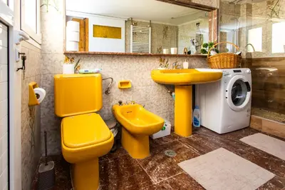 a bathroom with a yellow toilet and a sink at Ρετιρέ με θέα in Athens
