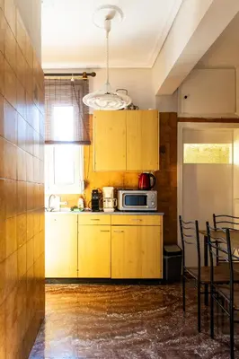 a kitchen with yellow cabinets and a microwave at Ρετιρέ με θέα in Athens